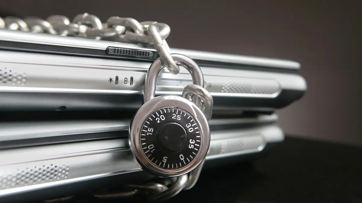 Laptop secured with a lock representing data privacy and cybersecurity compliance for technology businesses